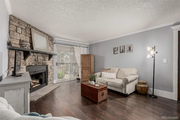 a living room with furniture a fireplace and a flat screen tv