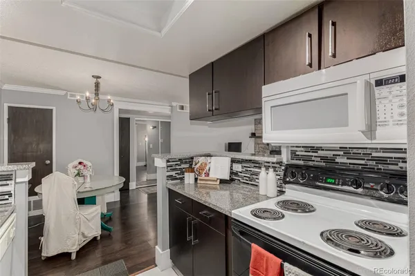 a kitchen with stainless steel appliances granite countertop a stove white cabinets a sink and dishwasher