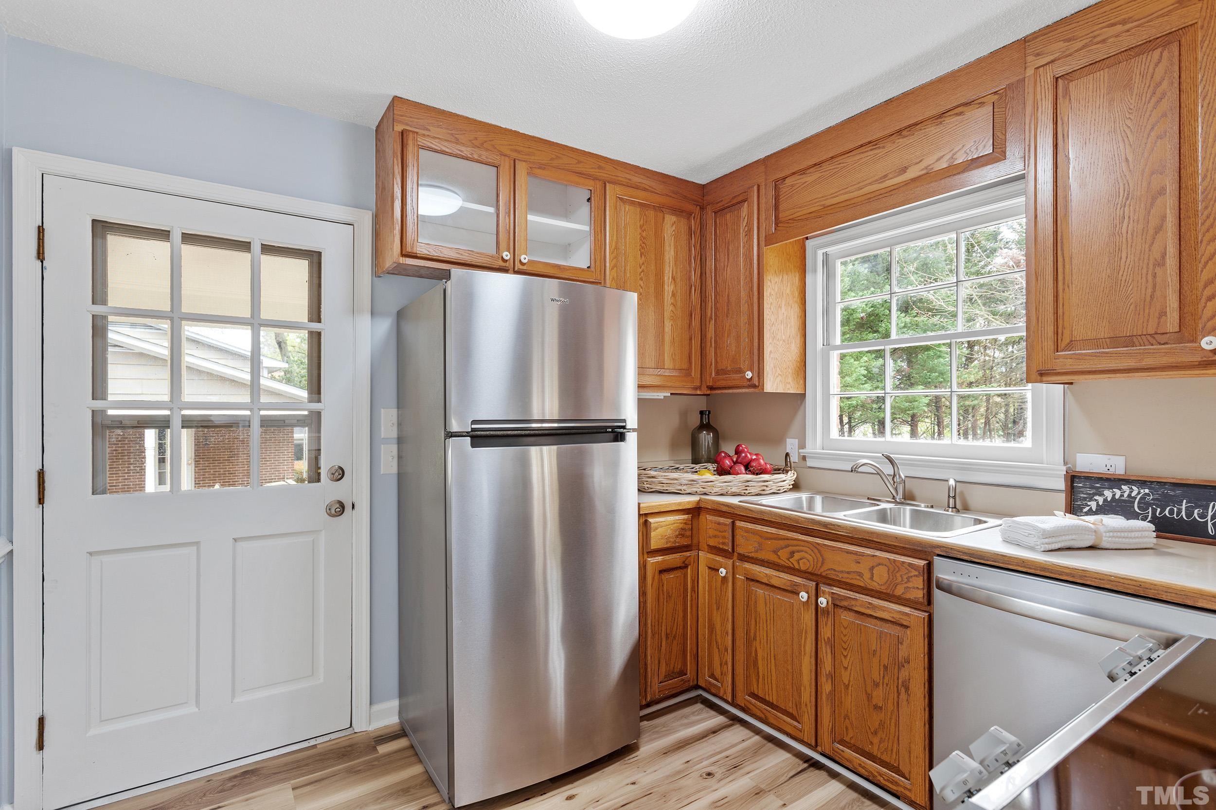 4108 Willow Oak Road Raleigh, NC 27604 - Photo 14 of 35 a kitchen with a refrigerator a sink and cabinets