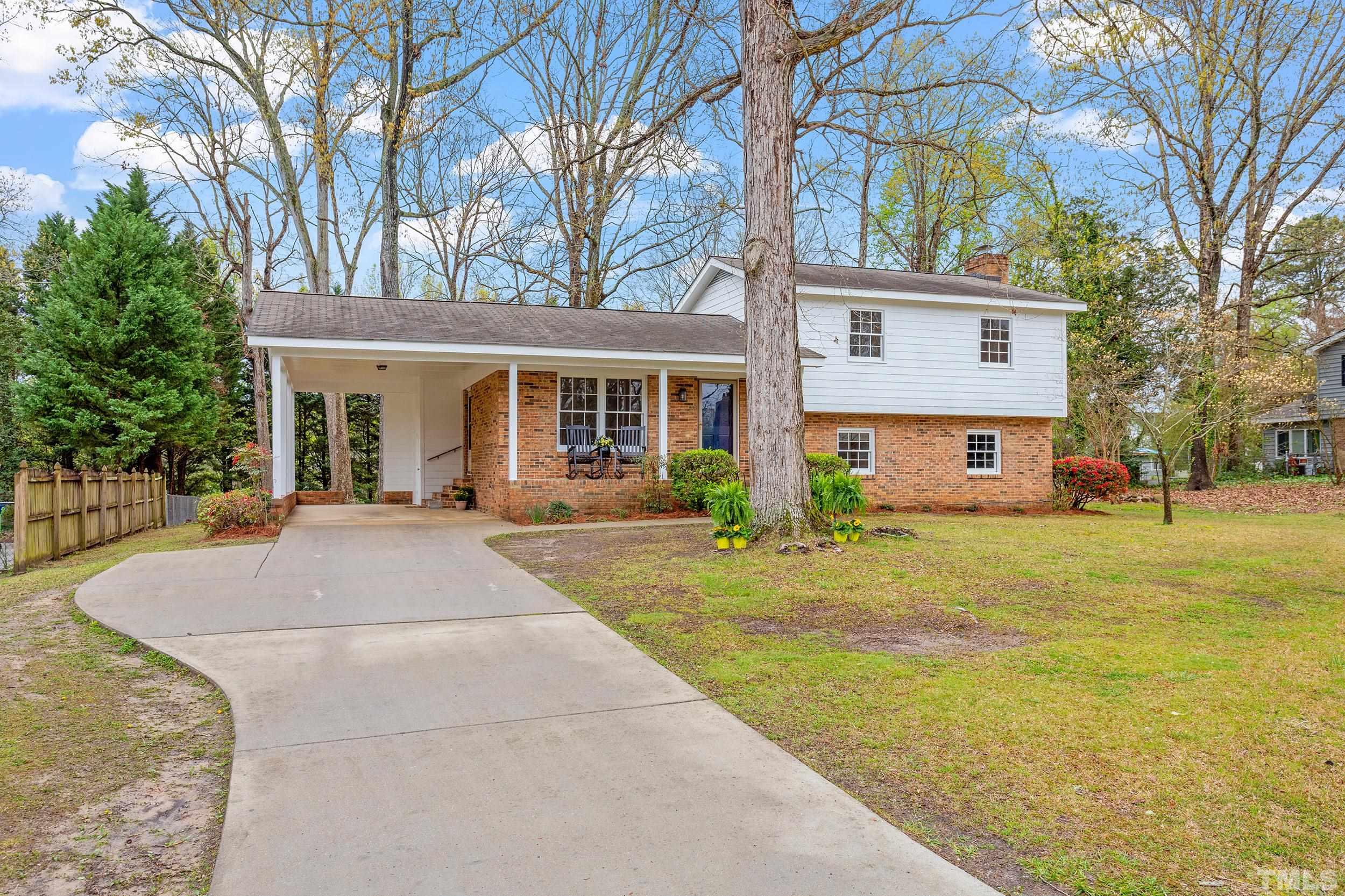 4108 Willow Oak Road Raleigh, NC 27604 - Photo 3 of 35 a front view of a house with a yard and trees
