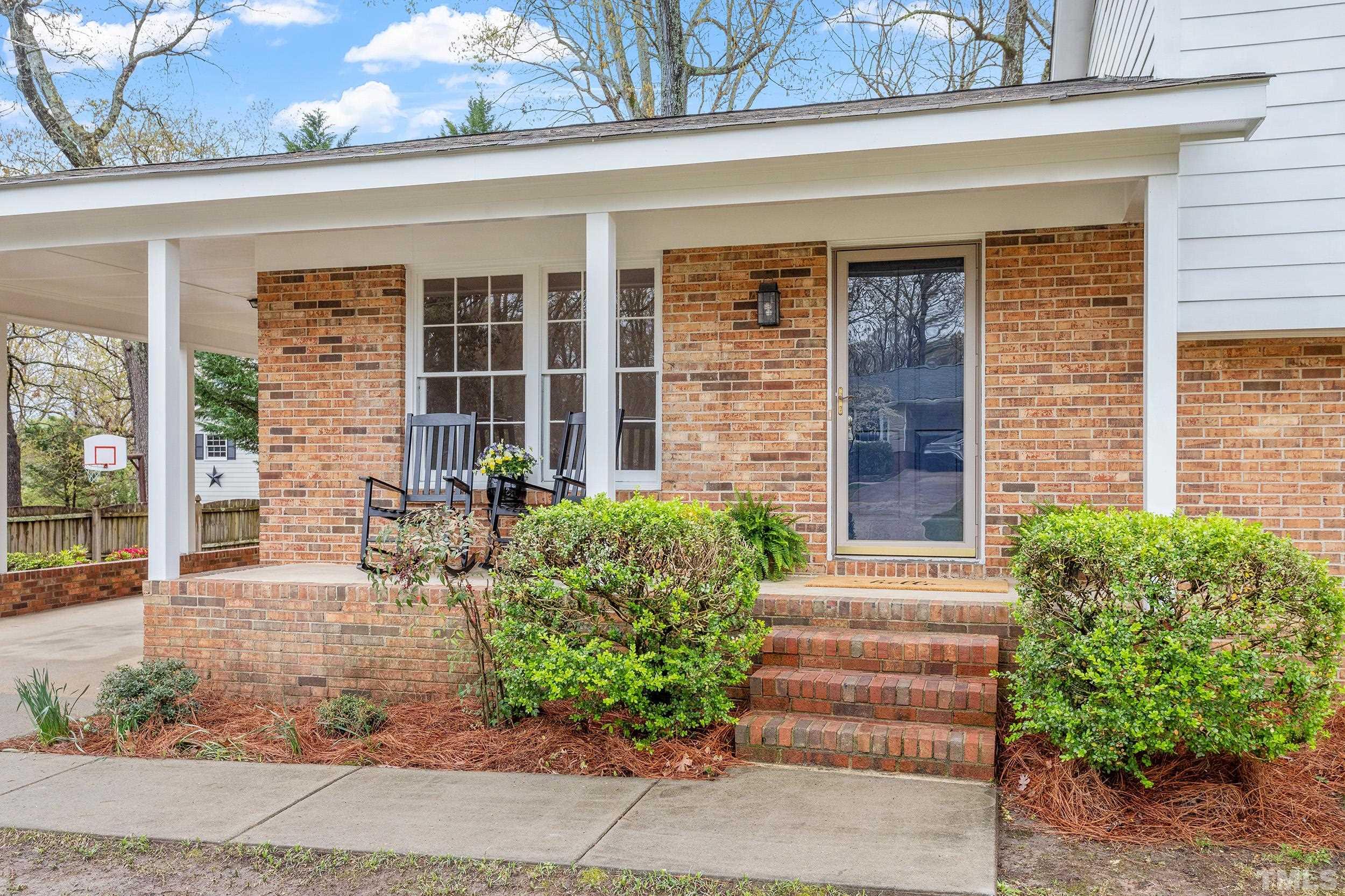 4108 Willow Oak Road Raleigh, NC 27604 - Photo 5 of 35 a front view of a house with a garden
