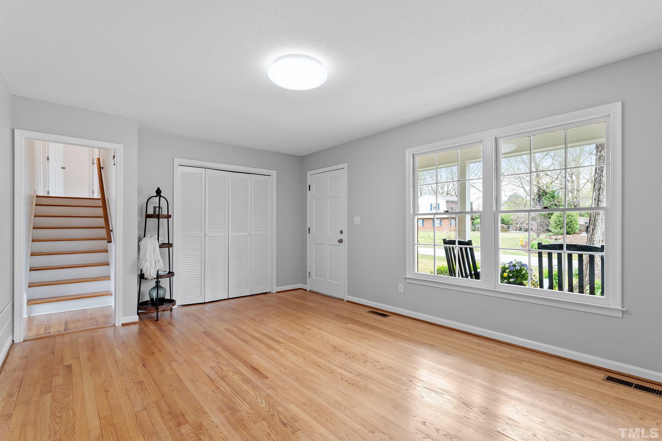4108 Willow Oak Road Raleigh, NC 27604 - Photo 10 of 35 a view of empty room with wooden floor and fan