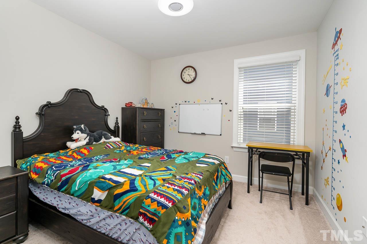 2003 Travern Drive Raleigh, NC 27603 - Photo 23 of 32 a bedroom with a bed and a table in it
