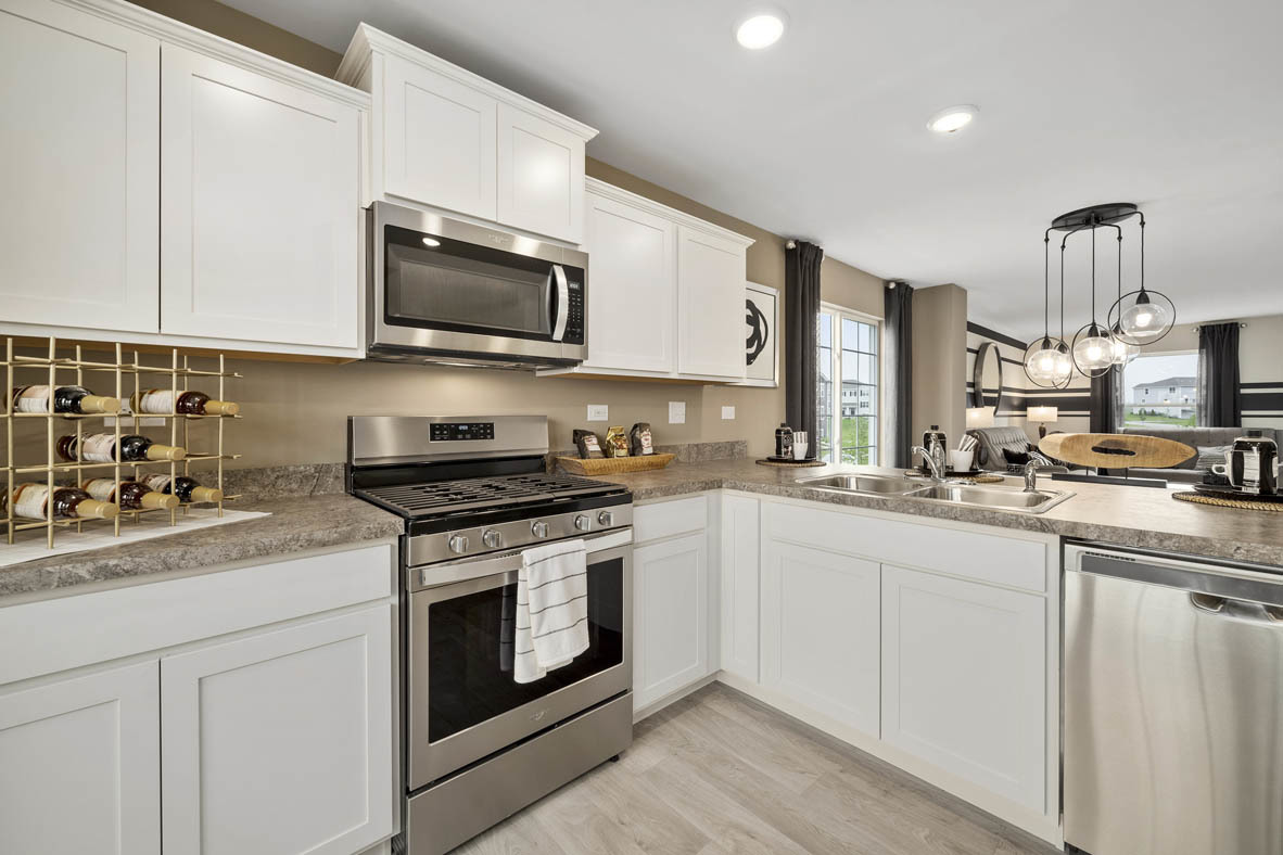 3732 Bailey Road Yorkville, IL 60560 - Photo 4 of 20 a kitchen with stainless steel appliances granite countertop a sink a stove a microwave and wooden cabinets