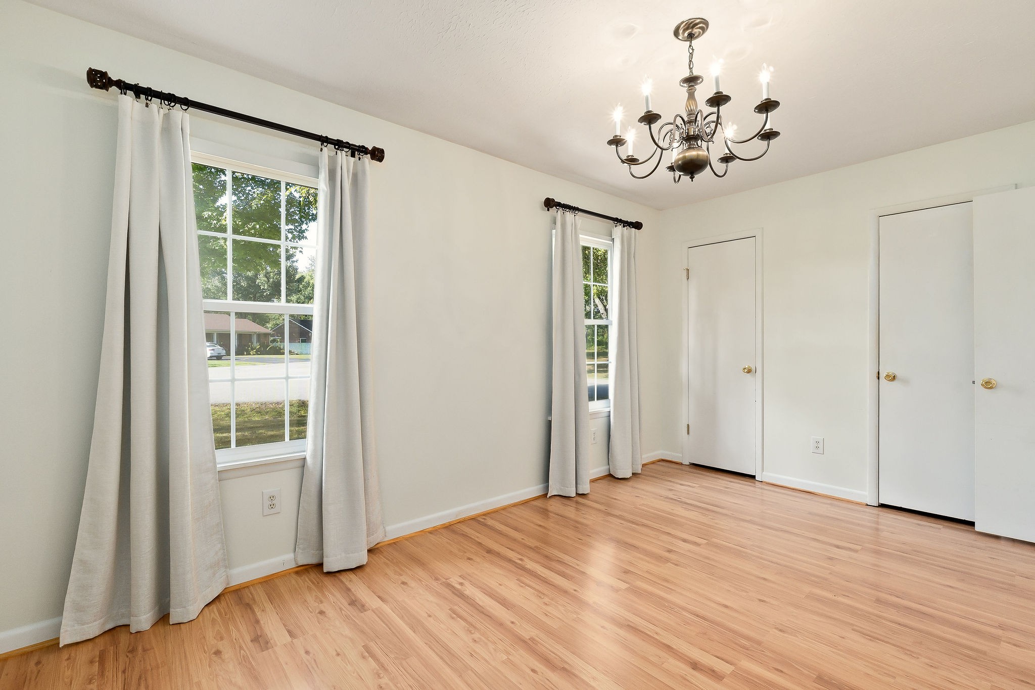 1175 Meadow Road Cookeville, TN 38501 - Photo 23 of 37 a view of a bedroom with wooden floor and a chandelier