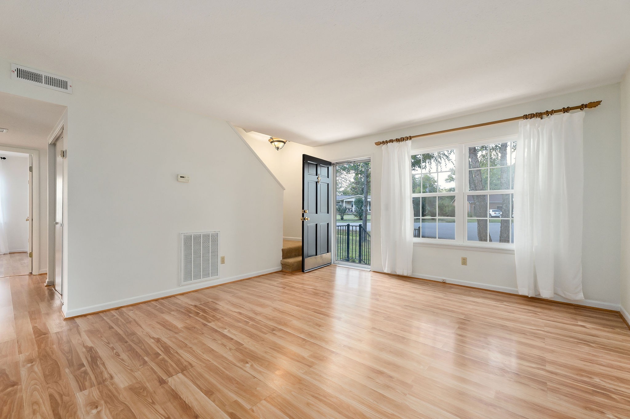 1175 Meadow Road Cookeville, TN 38501 - Photo 6 of 37 a view of an empty room with wooden floor and a window