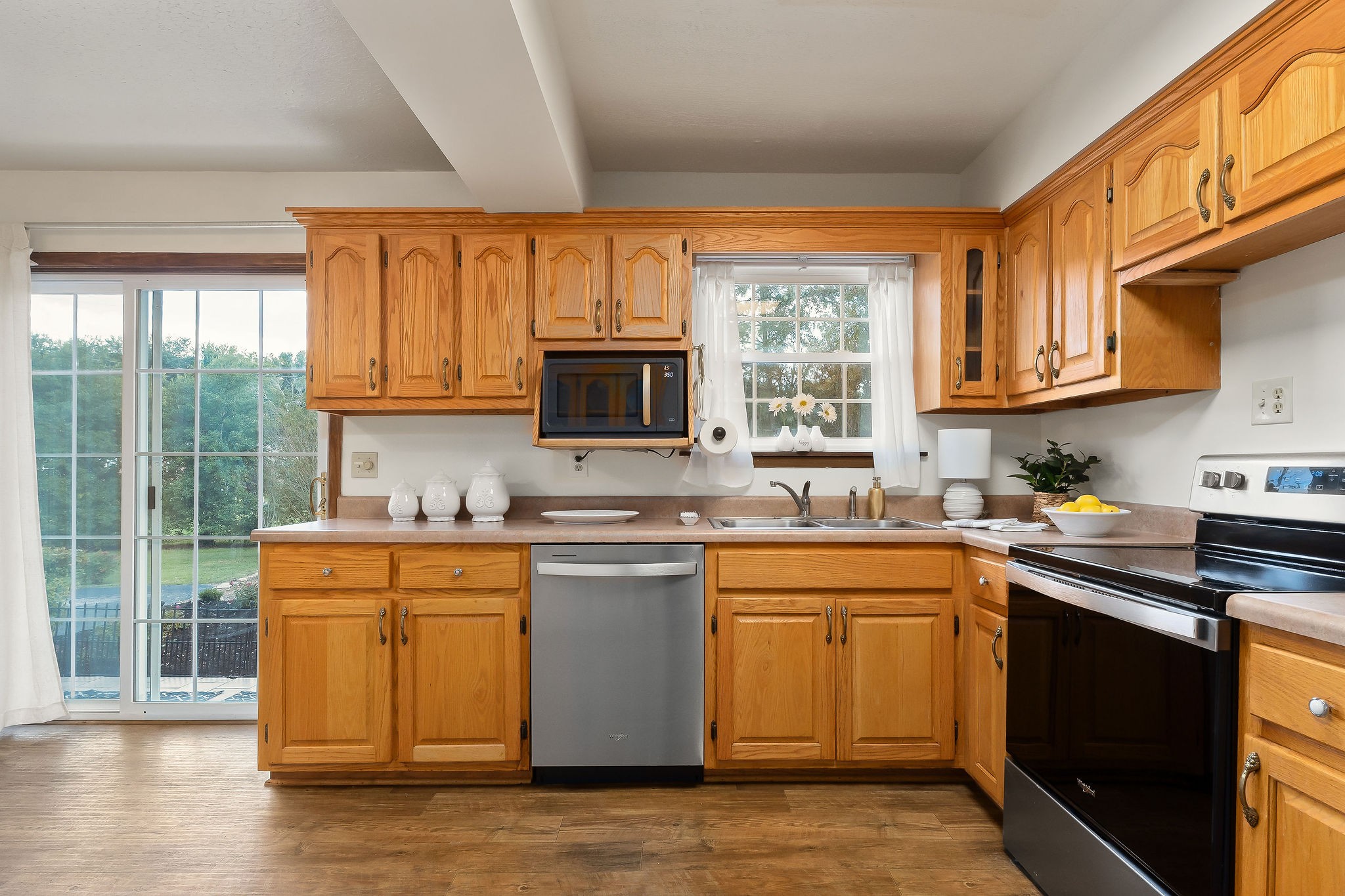 1175 Meadow Road Cookeville, TN 38501 - Photo 7 of 37 a kitchen with stainless steel appliances granite countertop a stove a sink dishwasher a microwave oven with cabinets and wooden floor