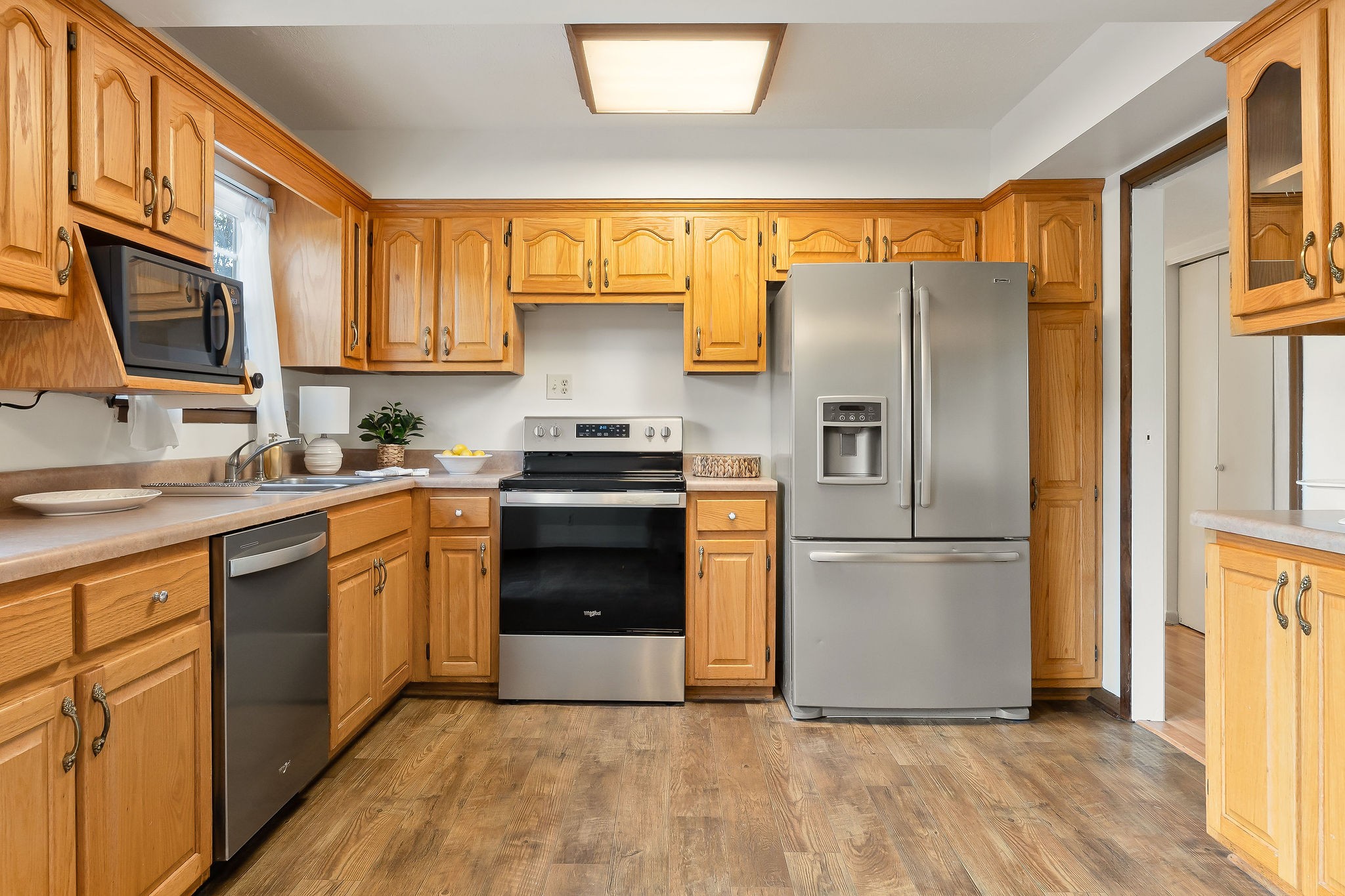 1175 Meadow Road Cookeville, TN 38501 - Photo 9 of 37 a kitchen with granite countertop stainless steel appliances a refrigerator stove top oven and sink