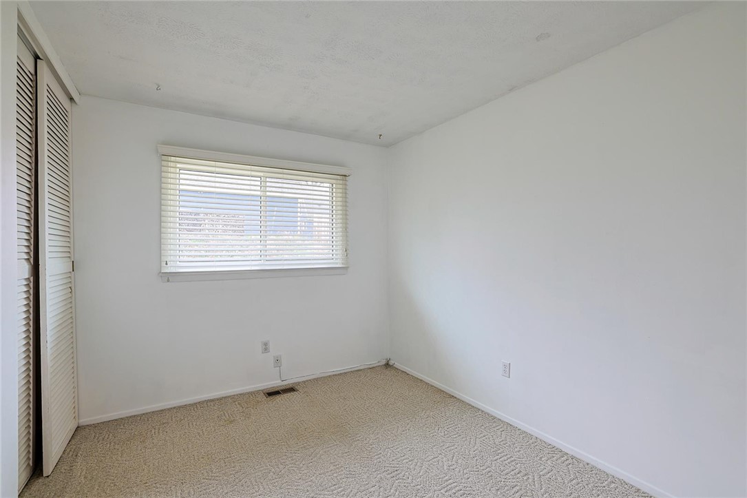 4307 Meadowcroft Road Dayton, OH 45429 - Photo 19 of 26 This bright room features a window with blinds, carpeted flooring, and a spacious closet.