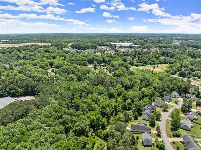 a view of a city with lush green forest