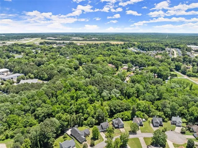 a view of a city with lush green forest