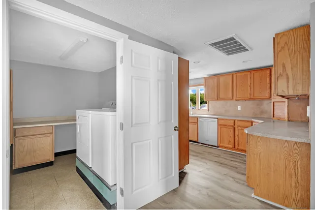 a kitchen with a refrigerator a stove top oven a sink and dishwasher