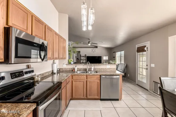 a kitchen with a sink and stainless steel appliances