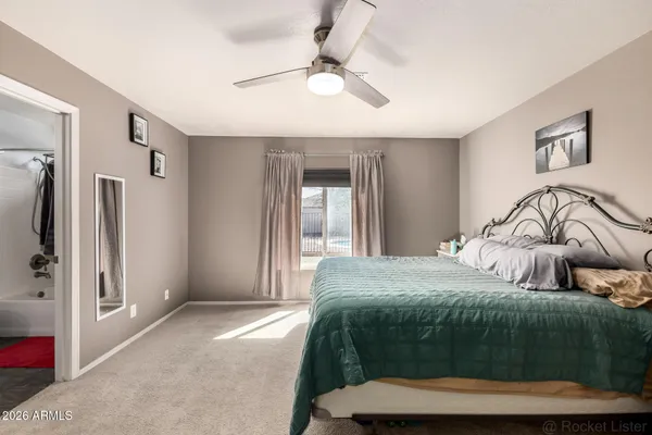 a bedroom with a bed and a painting on the wall