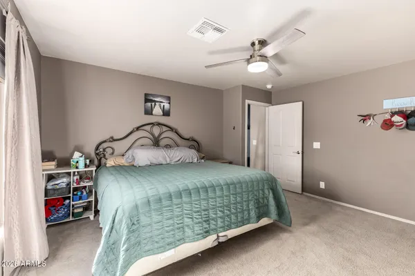 a bedroom with a bed and a ceiling fan