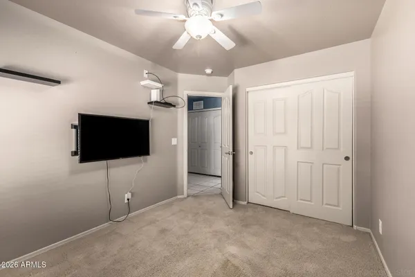 en empty room with ceiling fan and window
