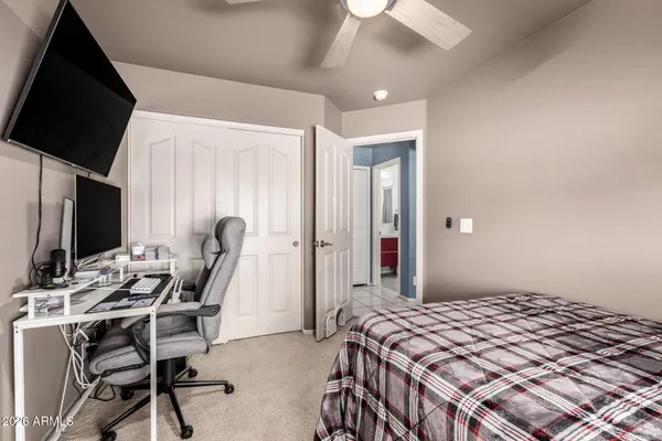 a bedroom with a bed and a flat screen tv