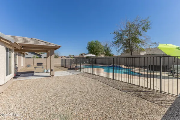 a view of a house with wooden fence