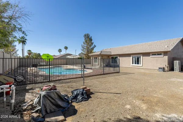 a view of a house with backyard and deck