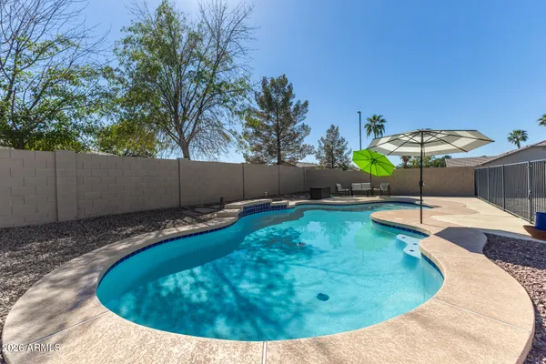 a swimming pool with outdoor seating and yard