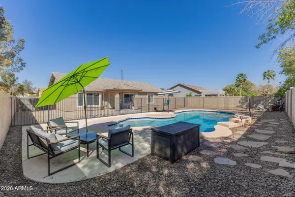a view of a house with backyard porch and sitting area