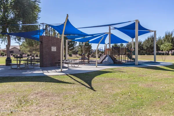 swimming pool view with a seating space and garden