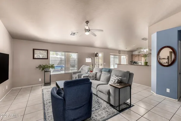a living room with furniture a large window and a clock