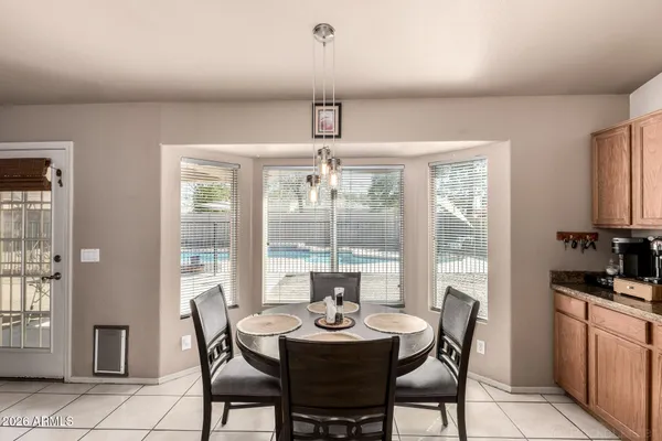 a dining room with furniture a chandelier and wooden floor
