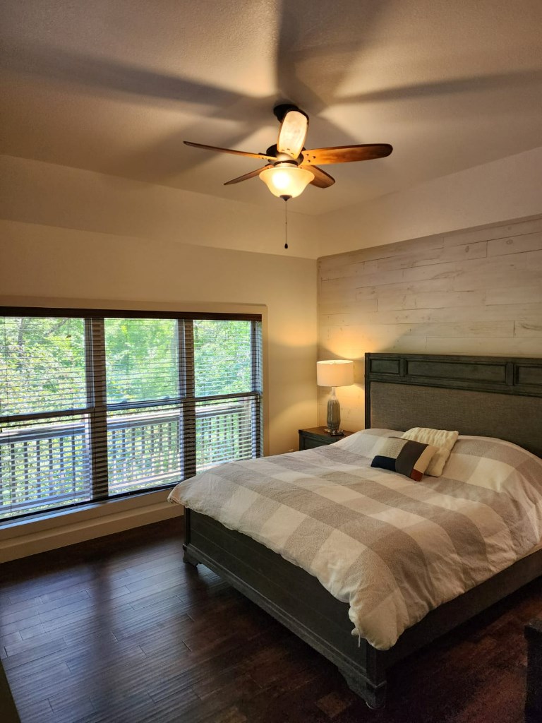 411 Delta Way Blue Ridge, GA 30513 - Photo 8 of 35 a bedroom with a large bed and a large window