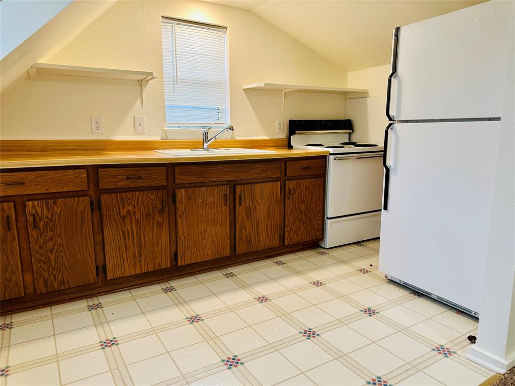 402 South Bryan-Belt Line Road Mesquite, TX 75149 - Photo 6 of 14 a kitchen with a sink appliances and cabinets