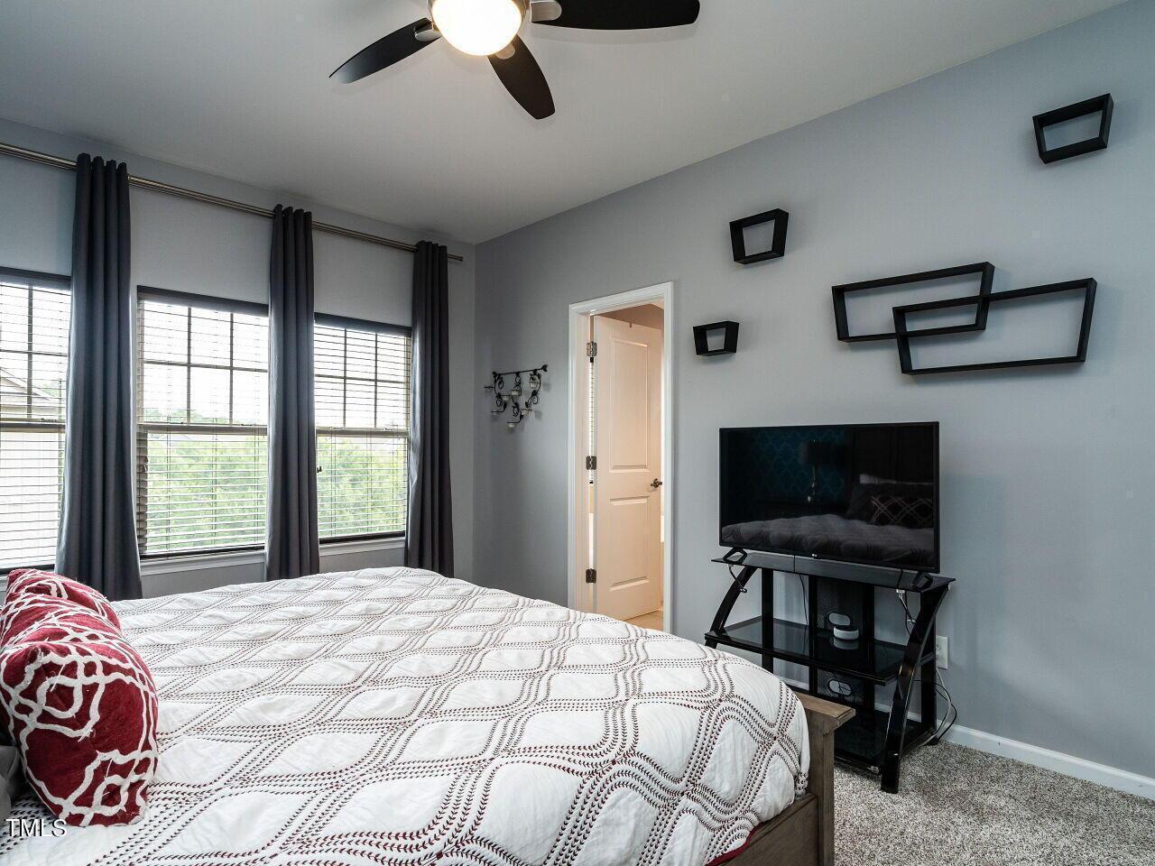 1316 Cornell Place Raleigh, NC 27607 - Photo 18 of 31 a bedroom with a bed a desk and chair with window