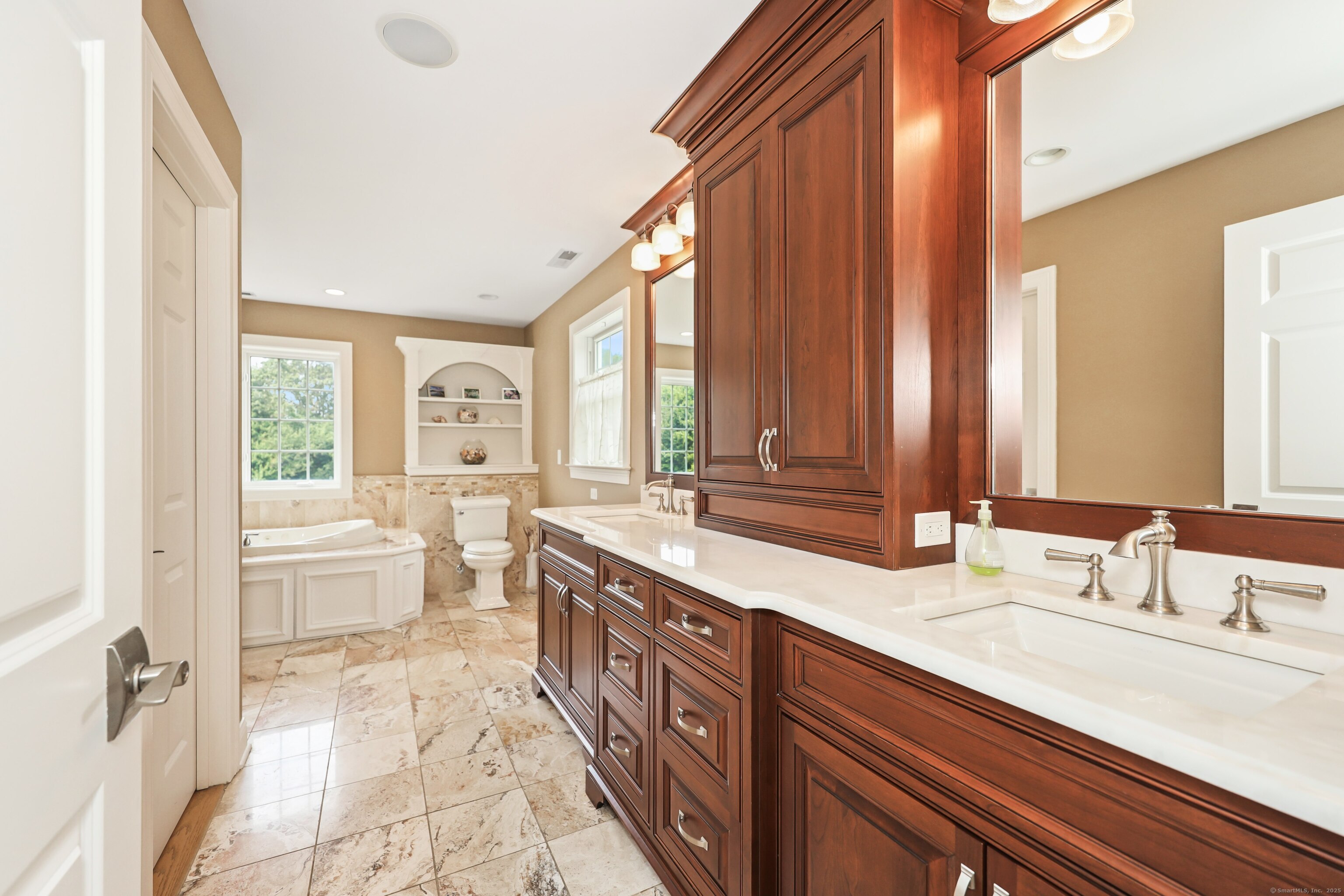 17 Hunters Ridge Wolcott, CT 06716 - Photo 23 of 40 a spacious bathroom with a double vanity sink a large mirror and a bathtub