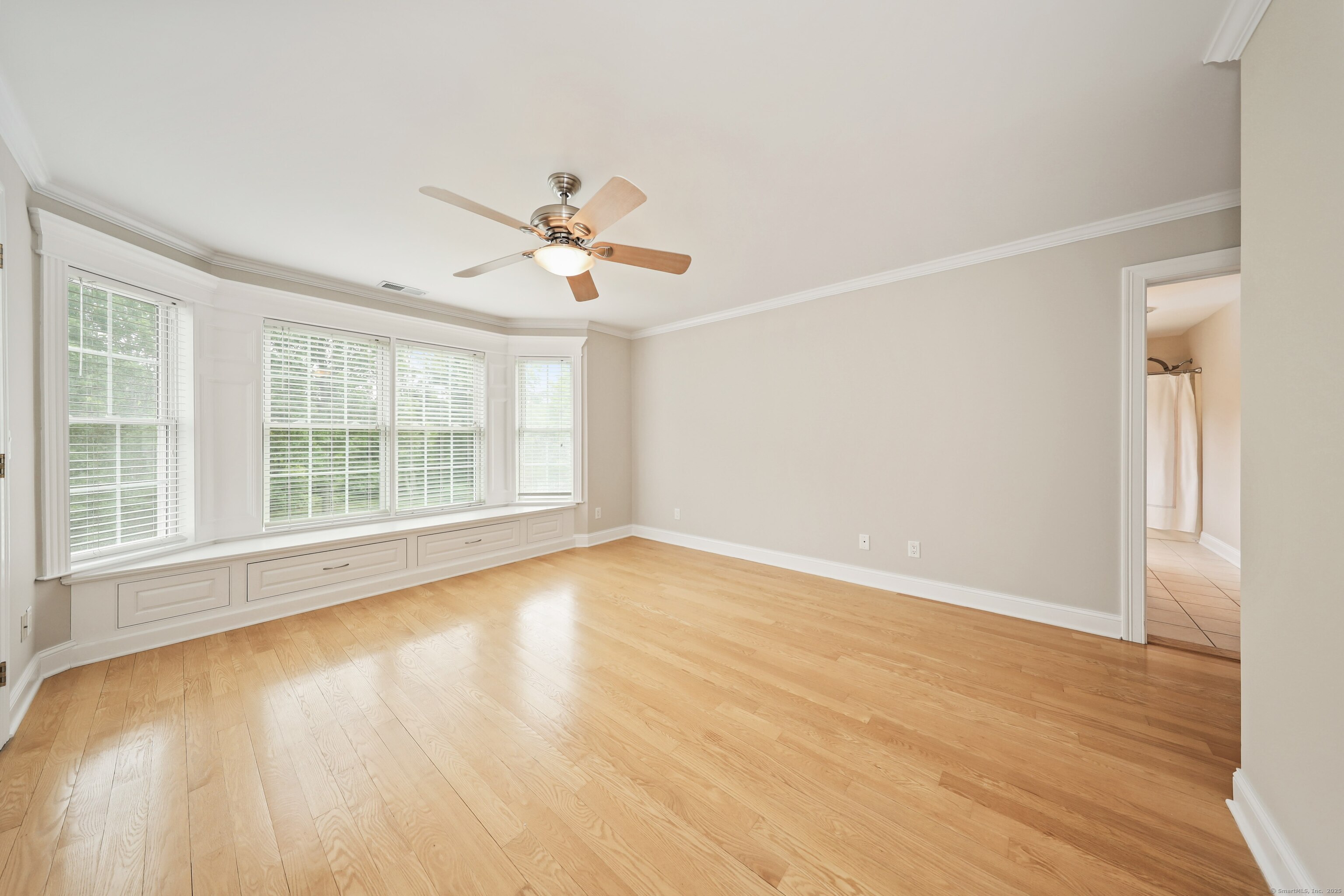 17 Hunters Ridge Wolcott, CT 06716 - Photo 26 of 40 a view of an empty room with a window and wooden floor
