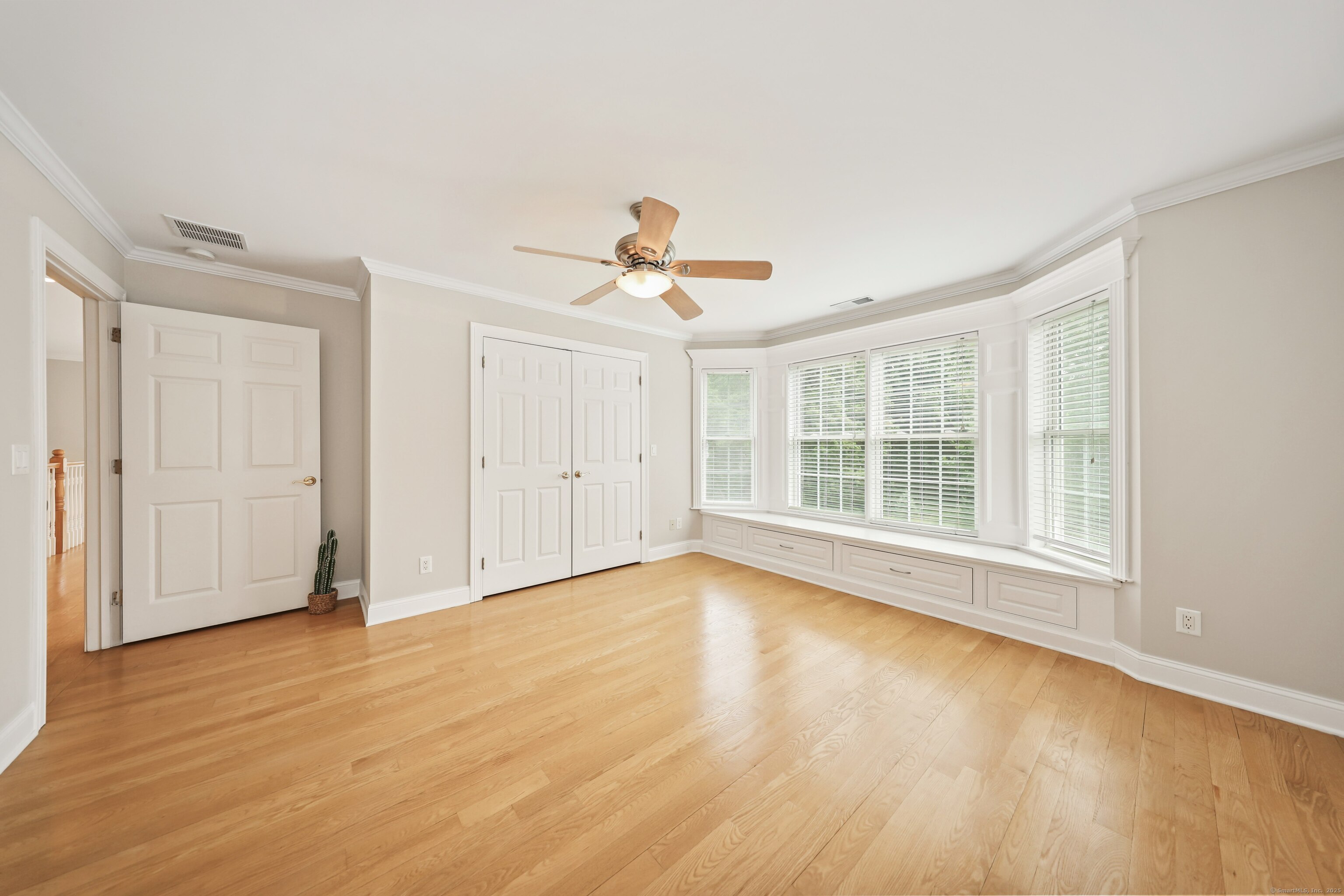 17 Hunters Ridge Wolcott, CT 06716 - Photo 28 of 40 a view of an empty room with wooden floor and a window