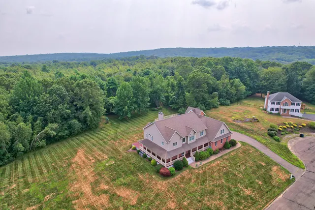 a view of a house with a yard and a large window