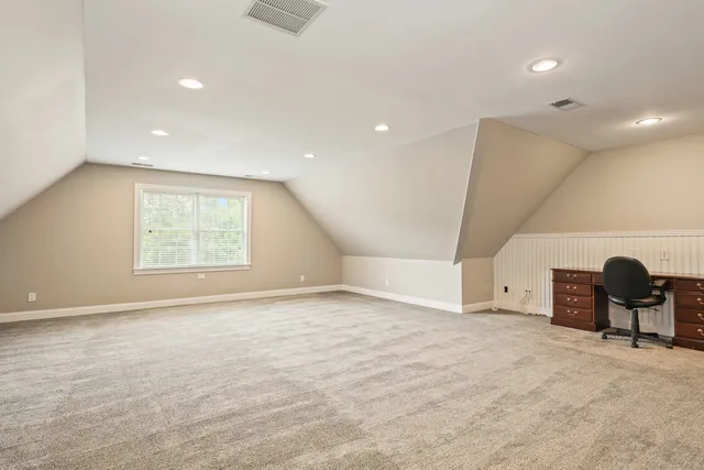 an empty room with windows and furniture