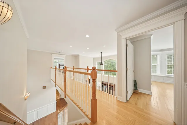 a view of a hallway with wooden floor and entryway