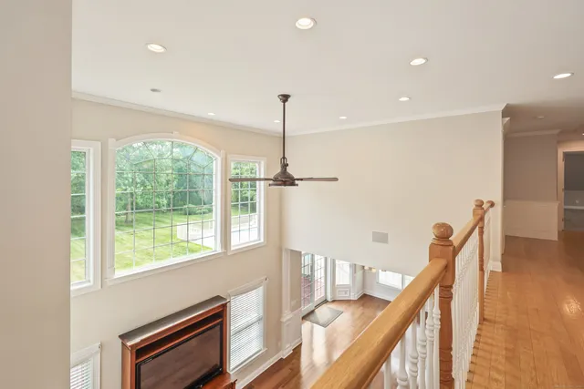 a view of hallway with furniture and stairs