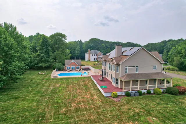 a front view of house with yard and swimming pool