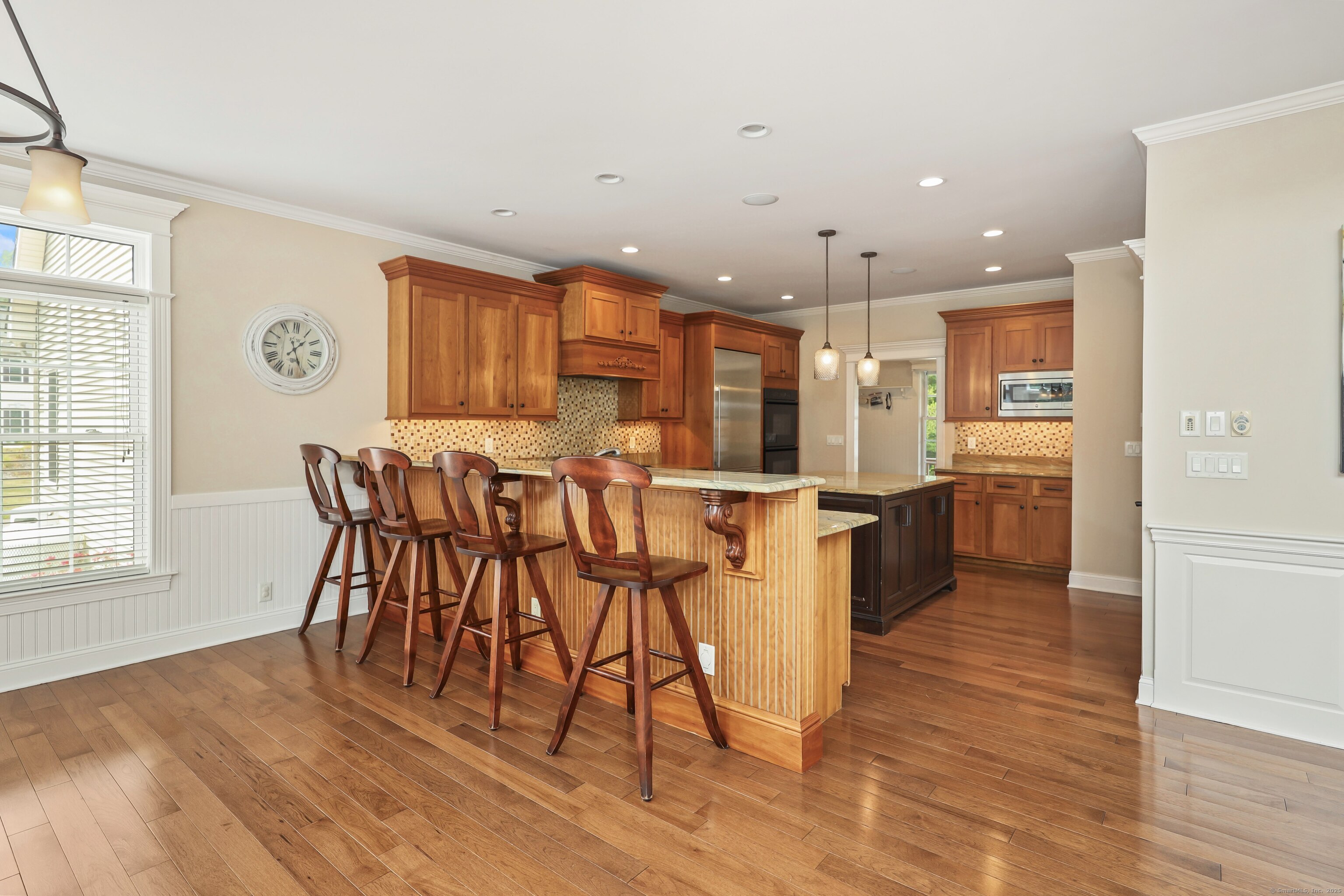 17 Hunters Ridge Wolcott, CT 06716 - Photo 7 of 40 a kitchen with stainless steel appliances kitchen island granite countertop a table chairs and a refrigerator
