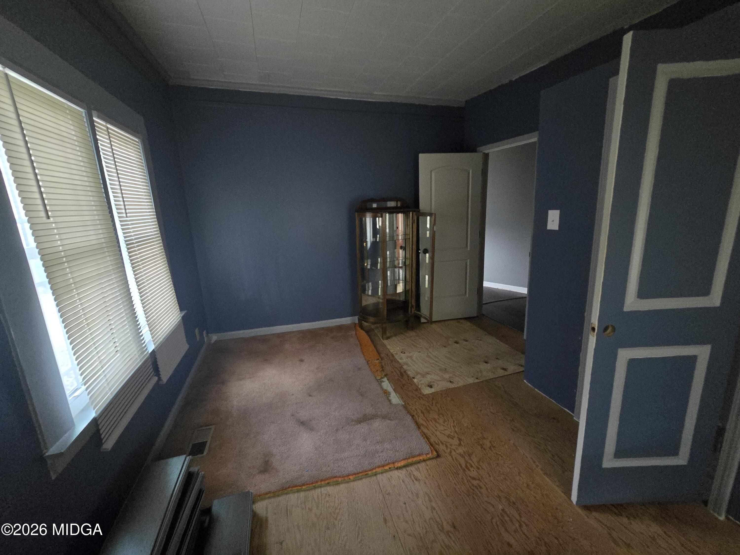 1070 Borum Street Unadilla, GA 31091 - Photo 11 of 18 a view of empty room with windows