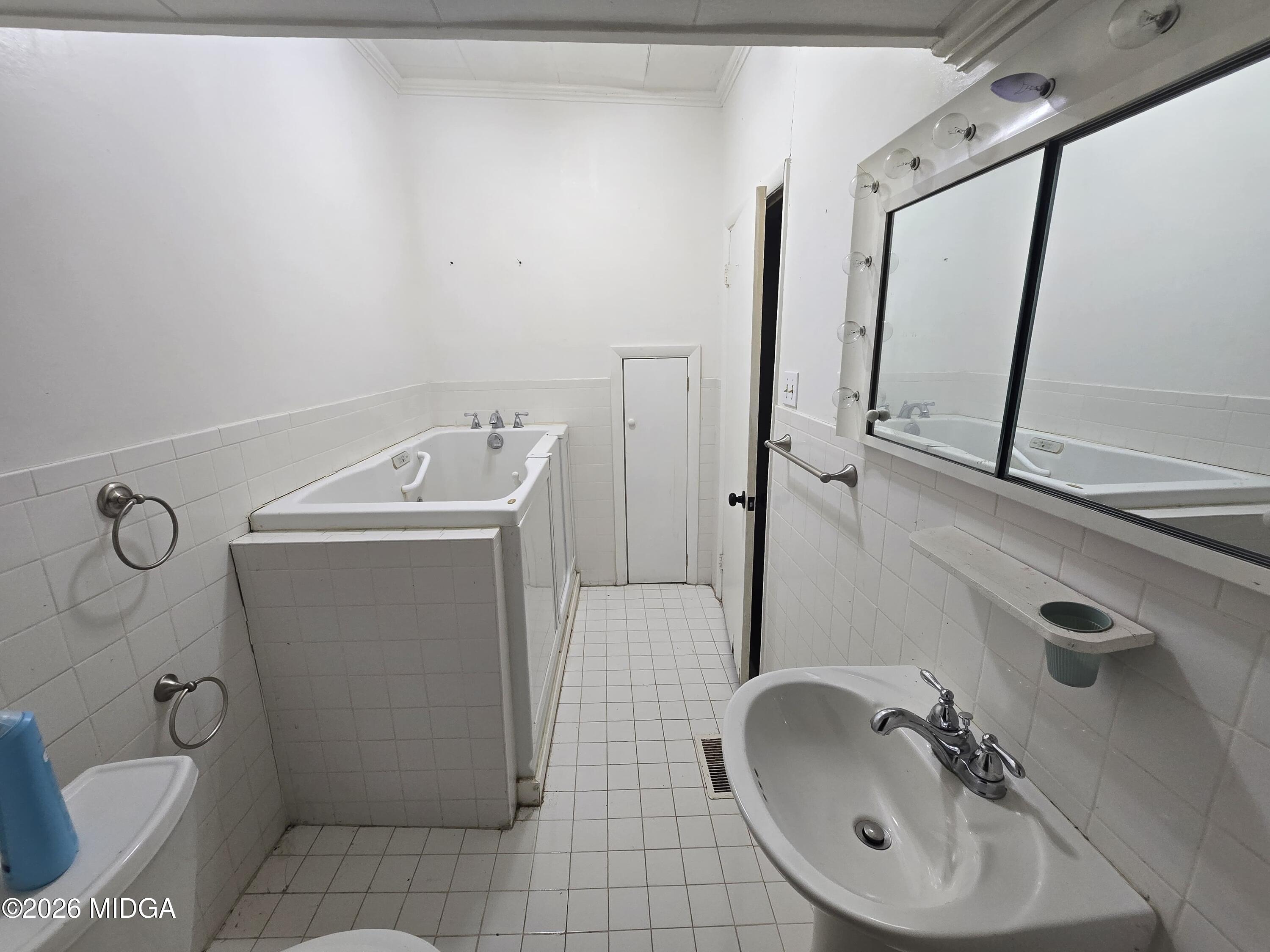 1070 Borum Street Unadilla, GA 31091 - Photo 14 of 18 a bathroom with a sink a toilet and shower