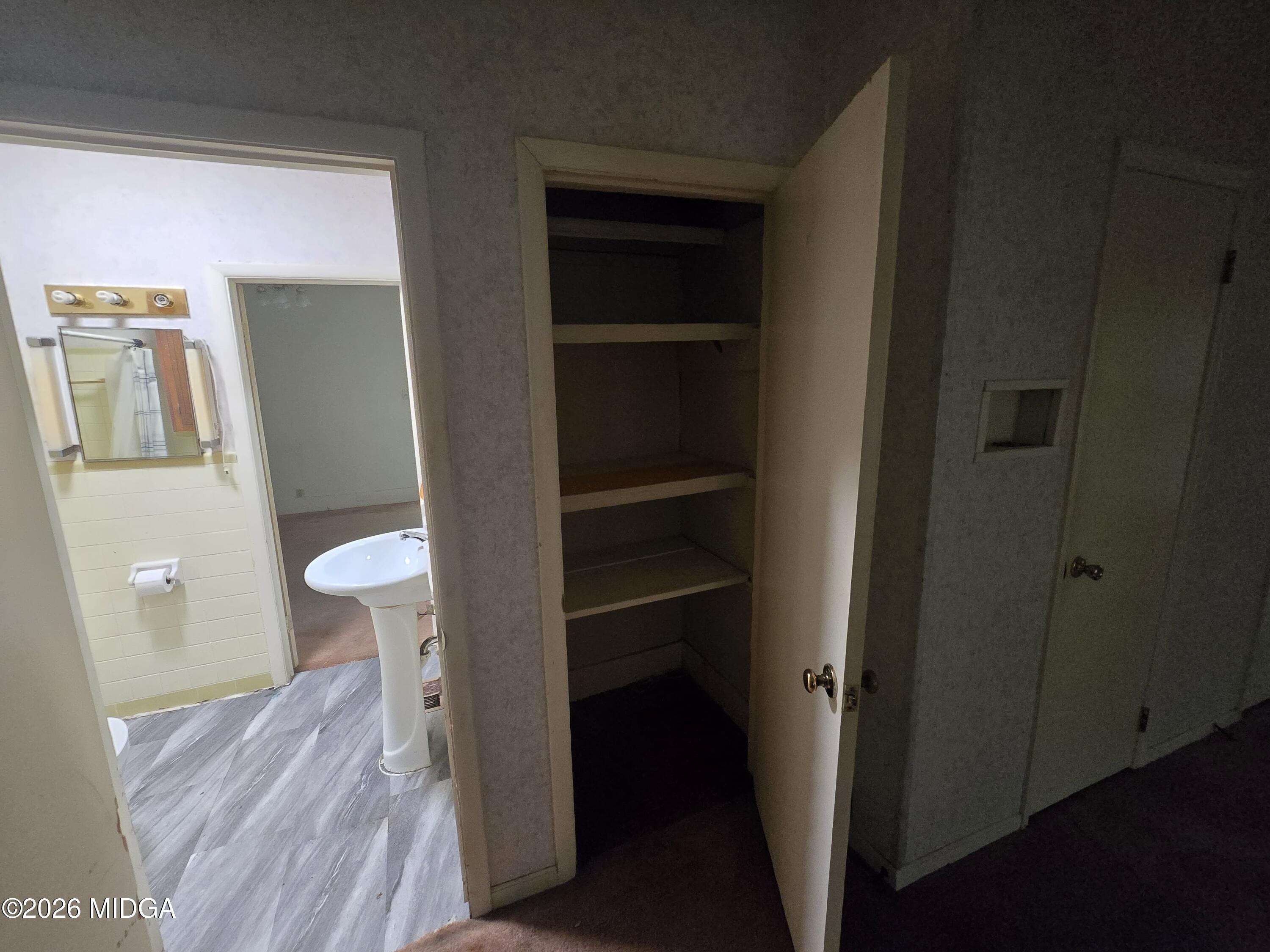 1070 Borum Street Unadilla, GA 31091 - Photo 5 of 18 a view of a bathroom from a hallway