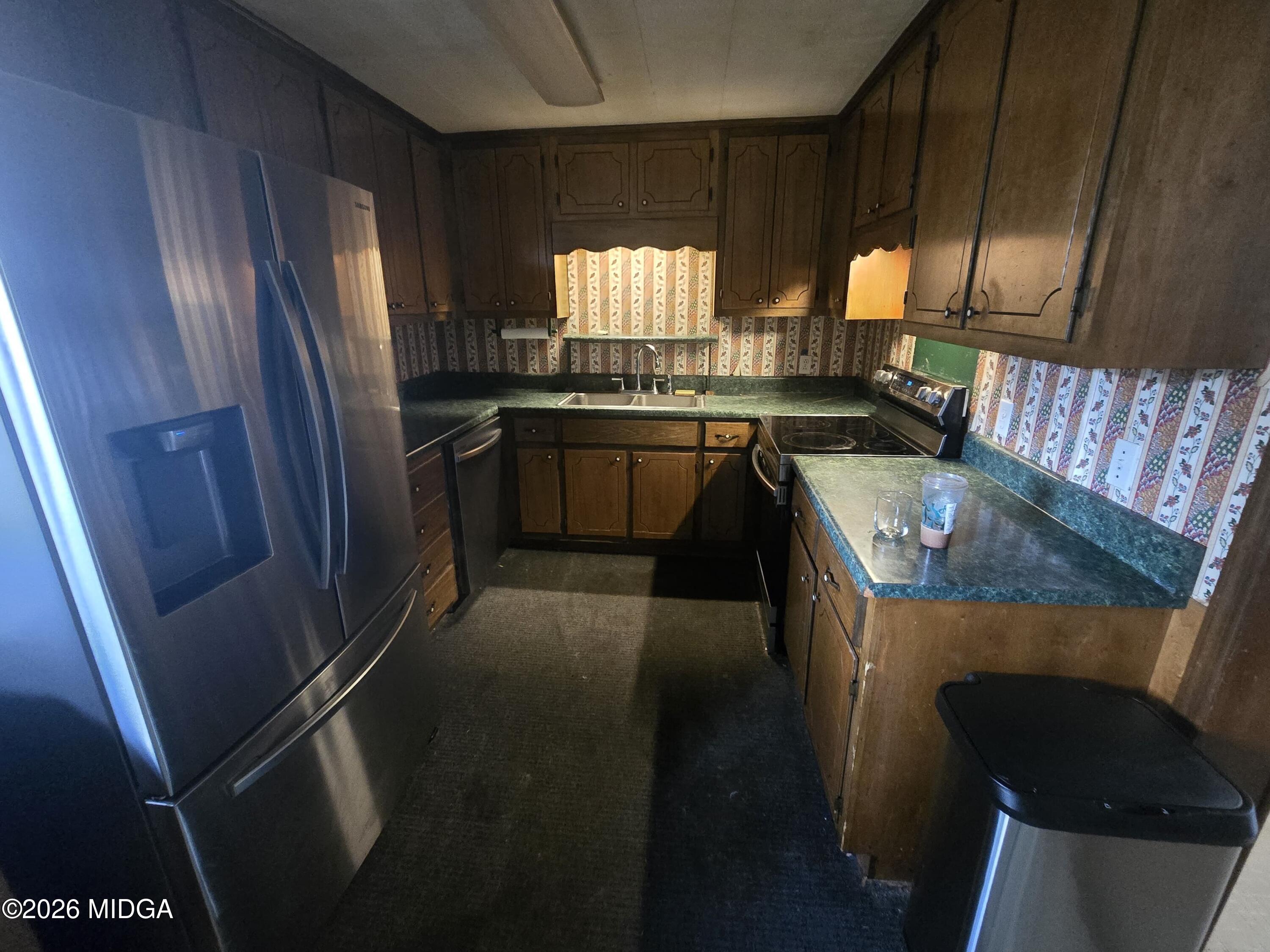 1070 Borum Street Unadilla, GA 31091 - Photo 10 of 18 a kitchen with refrigerator and window