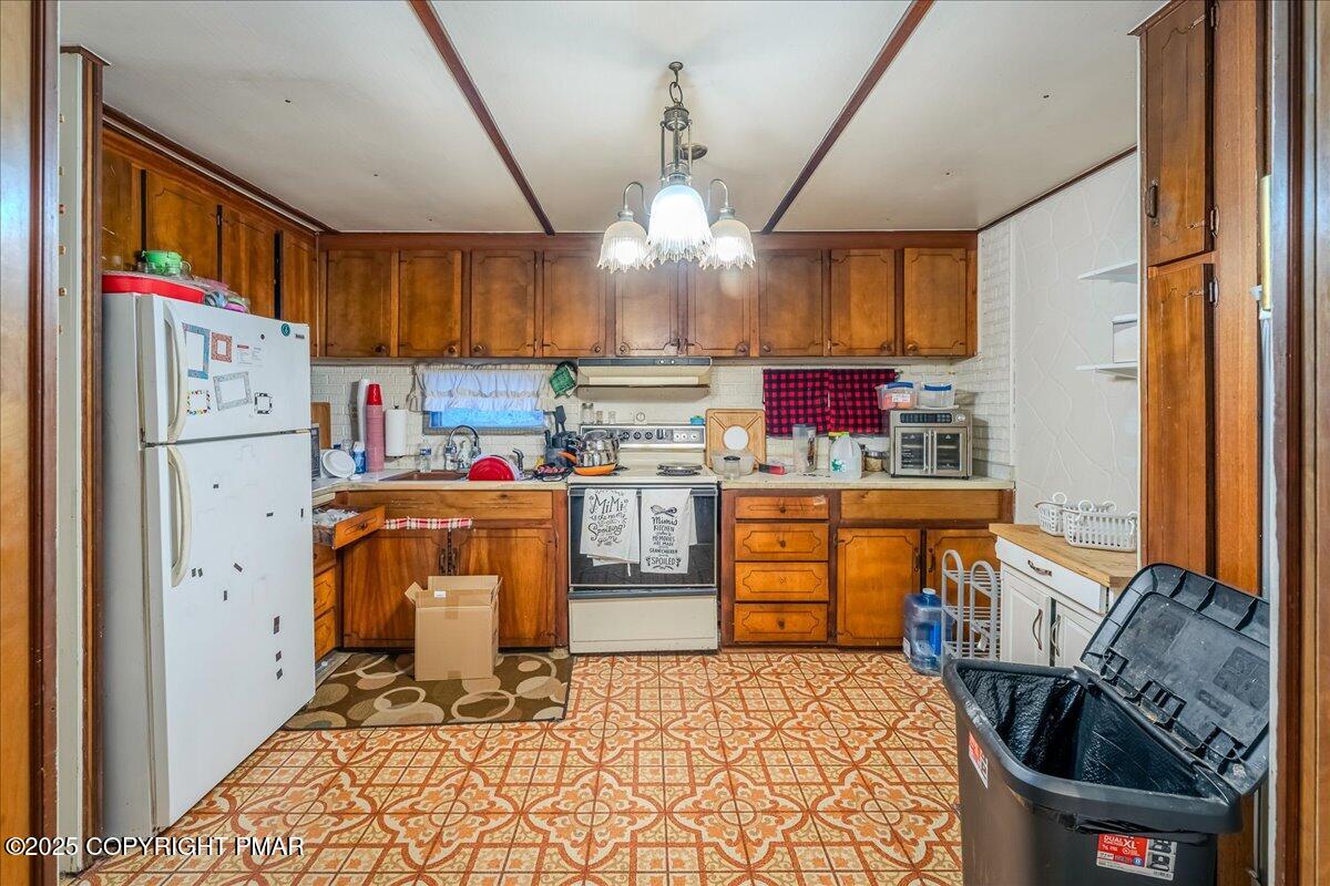 2099 North Turnpike Road Dalton, PA 18414 - Photo 6 of 16 a kitchen with refrigerator and cabinets