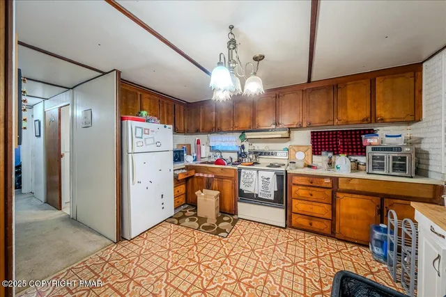 a kitchen with refrigerator cabinets and a wooden floor