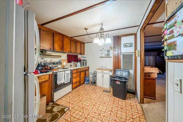 a kitchen with stainless steel appliances kitchen island granite countertop a refrigerator and a stove top oven