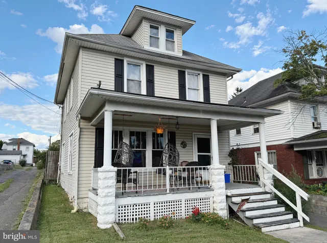 a front view of house with yard and outdoor seating