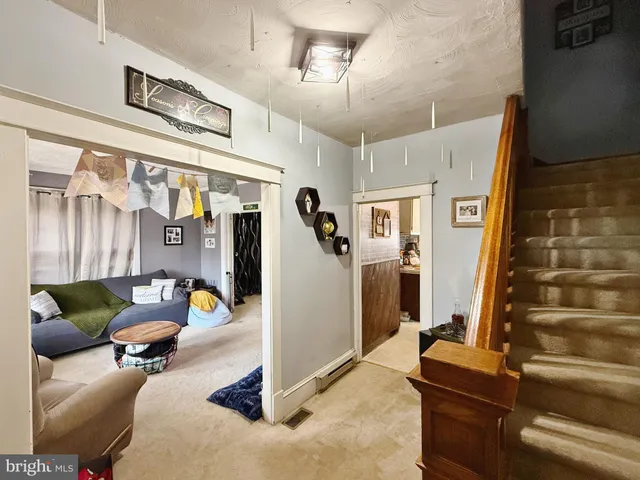 a living room with furniture and a mirror