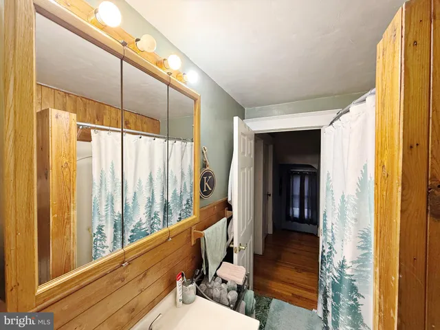 a bathroom with a large mirror and a shower
